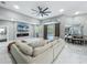 Modern living room with a large sofa, a fireplace, and a view of the pool through sliding glass doors, creating a relaxing ambiance at 704 Forest View Ct, Winter Springs, FL 32708