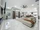 Spacious living room with sleek tile floors, stylish furniture, and an open layout leading to other areas of the house at 704 Forest View Ct, Winter Springs, FL 32708