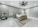Comfortable main bedroom with an ensuite bathroom, closet, and windows with a ceiling fan at 704 Forest View Ct, Winter Springs, FL 32708