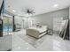 Spacious main bedroom with large windows, chandelier and pool view, features marble tile floors at 704 Forest View Ct, Winter Springs, FL 32708
