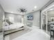 Bright main bedroom boasts a ceiling fan, lots of windows, and an ensuite bathroom at 704 Forest View Ct, Winter Springs, FL 32708