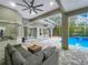 Inviting outdoor living area with a pool, seating, and screened enclosure at 704 Forest View Ct, Winter Springs, FL 32708