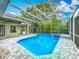 The screened pool area offers both a pool and spa, plus an outdoor kitchen for easy entertaining at 704 Forest View Ct, Winter Springs, FL 32708