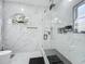 Luxurious bathroom features a spacious shower with glass enclosure, marble walls, and hexagon tile flooring at 704 Forest View Ct, Winter Springs, FL 32708