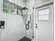 Updated shower with sleek fixtures, marble tile, and a glass enclosure at 704 Forest View Ct, Winter Springs, FL 32708