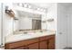 Bathroom featuring double sinks with granite countertop and well lit vanity at 8164 Wood Sage Dr, Winter Garden, FL 34787