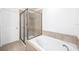 Relaxing bathroom with a soaking tub and separate tiled shower at 8164 Wood Sage Dr, Winter Garden, FL 34787