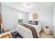 Cozy bedroom with bright natural light, decorative mirror and throw blankets at 8164 Wood Sage Dr, Winter Garden, FL 34787