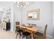 Chic dining room features wood table, chairs, and modern light fixture at 8164 Wood Sage Dr, Winter Garden, FL 34787