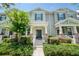 Inviting two-story townhouse with fresh landscaping and a welcoming front porch at 8164 Wood Sage Dr, Winter Garden, FL 34787