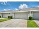 Home exterior with three garages, well-maintained landscaping, and a concrete driveway at 8164 Wood Sage Dr, Winter Garden, FL 34787