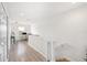 Upstairs hallway with light wood floors, leading to a cozy office area at 8164 Wood Sage Dr, Winter Garden, FL 34787