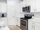 Kitchen with stainless steel oven, black cooktop and white cabinets at 8164 Wood Sage Dr, Winter Garden, FL 34787