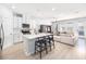 Bright open concept living space with white cabinets and a large island with seating at 8164 Wood Sage Dr, Winter Garden, FL 34787
