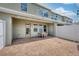 Charming outdoor patio space with brick pavers, string lights, and white privacy fence at 8164 Wood Sage Dr, Winter Garden, FL 34787