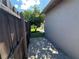 Backyard view with privacy fence and patio area; shaded by a tree at 8258 Golden Chickasaw Cir, Orlando, FL 32825