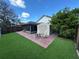 Inviting backyard with screened-in patio, shed, and artificial grass at 8258 Golden Chickasaw Cir, Orlando, FL 32825