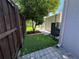 Backyard with lush artificial grass, stone patio, and shade tree at 8258 Golden Chickasaw Cir, Orlando, FL 32825