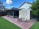 Inviting backyard with screened-in patio, shed, and artificial grass at 8258 Golden Chickasaw Cir, Orlando, FL 32825