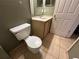 Bathroom featuring toilet, sink, and cabinet, with tiled floor at 8258 Golden Chickasaw Cir, Orlando, FL 32825