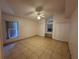 Bedroom featuring tile floors, a ceiling fan, and double closets with a built-in window bench at 8258 Golden Chickasaw Cir, Orlando, FL 32825