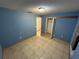 This is a tile floored bedroom with a view to the hallway and a closet at 8258 Golden Chickasaw Cir, Orlando, FL 32825