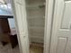 This is a shelved closet adjacent to a bedroom with a desk and a ceiling fan at 8258 Golden Chickasaw Cir, Orlando, FL 32825