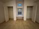 Double closets with a built-in window bench and tile flooring in bedroom at 8258 Golden Chickasaw Cir, Orlando, FL 32825