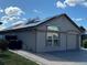 Charming home exterior with solar panels and paved driveway at 8258 Golden Chickasaw Cir, Orlando, FL 32825
