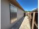 Side of house with brick pathway and hurricane shutters at 8258 Golden Chickasaw Cir, Orlando, FL 32825