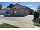 Attractive single-story home featuring a two-car garage, and a nicely paved driveway, with some mature landscaping at 8258 Golden Chickasaw Cir, Orlando, FL 32825