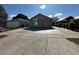 Well-kept single-story house showcasing a two-car garage, a driveway, and low maintenance landscaping at 8258 Golden Chickasaw Cir, Orlando, FL 32825