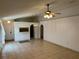 Inviting living area featuring neutral decor, tile flooring, and a partial wall view of the adjacent kitchen at 8258 Golden Chickasaw Cir, Orlando, FL 32825