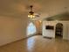 Comfortable living area with neutral decor, tile floors, and a partial view to the kitchen through a pass-through counter at 8258 Golden Chickasaw Cir, Orlando, FL 32825