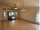 Bright living room with tile flooring, ceiling fan, and ample natural light, showcasing a view of the screened patio at 8258 Golden Chickasaw Cir, Orlando, FL 32825