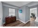 Neutral bedroom with wood floors, blinds, and a wood dresser with decor accents at 8968 Hildreth Ave, Orlando, FL 32832