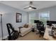 Versatile bedroom offering desk space, comfy chaise lounge, and modern ceiling fan at 8968 Hildreth Ave, Orlando, FL 32832