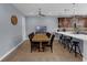 Open-concept dining area with wood table and leather chairs, and breakfast bar seating at 8968 Hildreth Ave, Orlando, FL 32832