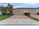 Paver driveway leads to the two-car garage in this townhome at 8968 Hildreth Ave, Orlando, FL 32832