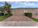 Paver driveway leads to the two-car garage in this townhome at 8968 Hildreth Ave, Orlando, FL 32832