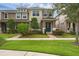 Inviting townhome featuring a blue front door, brick pathway, and landscaped yard at 8968 Hildreth Ave, Orlando, FL 32832
