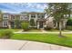 Beautiful townhome with a well-kept lawn, brick walkway, and meticulously maintained landscaping at 8968 Hildreth Ave, Orlando, FL 32832