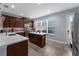 Modern kitchen with white counters, stainless appliances, and a center island with seating at 8968 Hildreth Ave, Orlando, FL 32832