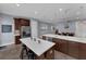Open kitchen with quartz countertops, stainless appliances, and a large center island with seating at 8968 Hildreth Ave, Orlando, FL 32832