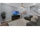 Cozy living room with a plush sofa, stylish decor, and a ceiling fan for added comfort at 8968 Hildreth Ave, Orlando, FL 32832