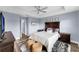 Relaxing primary bedroom with a comfortable bed, stylish decor, and a ceiling fan for optimal comfort at 8968 Hildreth Ave, Orlando, FL 32832