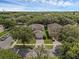 Aerial view of two homes in a neighborhood with mature trees lining the street at 9031 Stonebury Way, Orlando, FL 32832