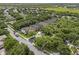 Aerial view of a home in a neighborhood with mature trees, sidewalks, and well-kept lawns at 9031 Stonebury Way, Orlando, FL 32832