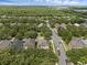 Aerial view of a suburban neighborhood featuring lush tree coverage, well-maintained homes, and quiet streets at 9031 Stonebury Way, Orlando, FL 32832