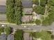 Birds-eye shot of houses along a quiet street, emphasizing the well-spaced lots, verdant trees, and the desirable neighborhood layout at 9031 Stonebury Way, Orlando, FL 32832